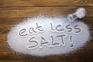 Eat less salt written on a heap of salt - antihypertensive campaign