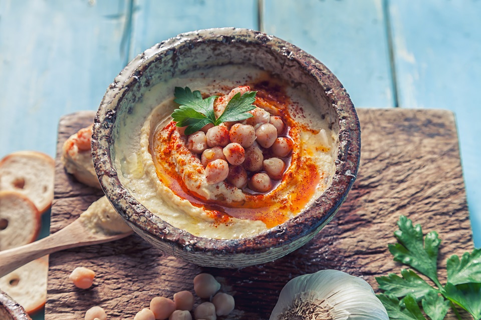 Bowl of hummus topped with whole garbanzo beans