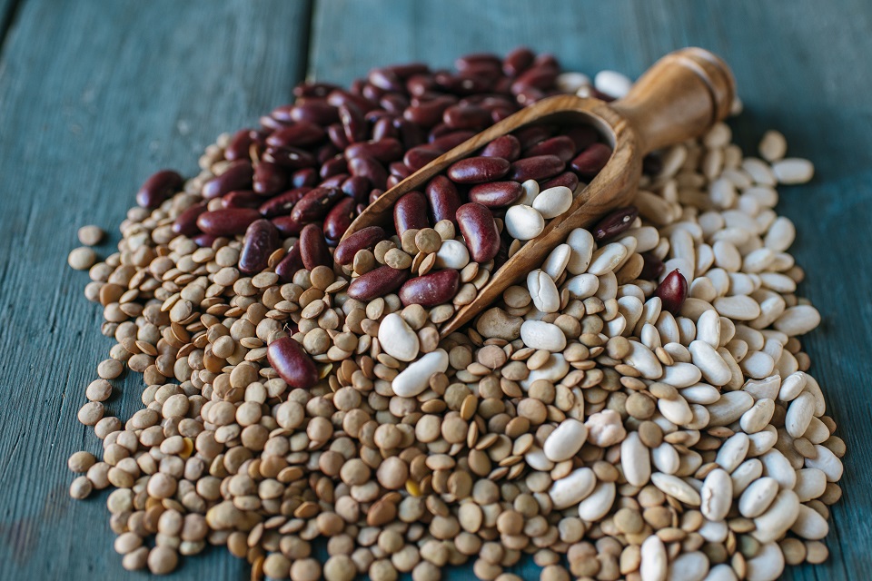 Lentils, red and white beans on blue wood