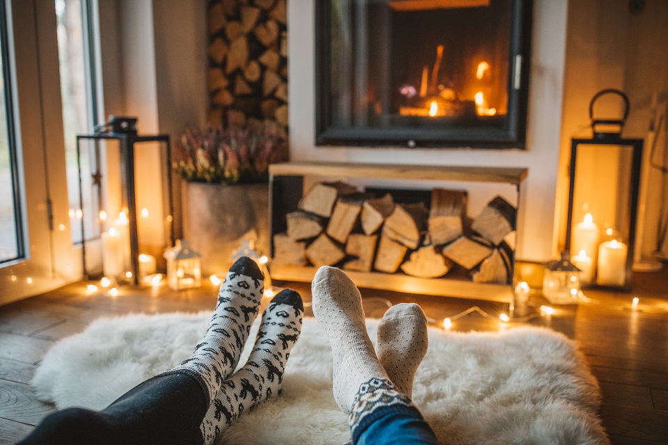 Couple in front of fireplace.